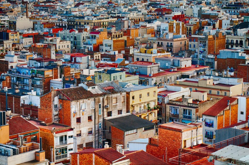 A dense residential neighborhood showing rooftops, apartment buildings, and houses spread across an urban area.